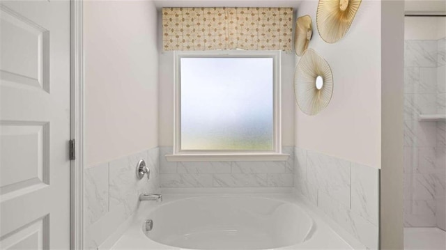 bathroom with plenty of natural light and separate shower and tub