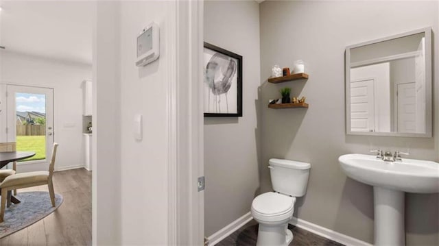 bathroom featuring hardwood / wood-style floors, toilet, and sink