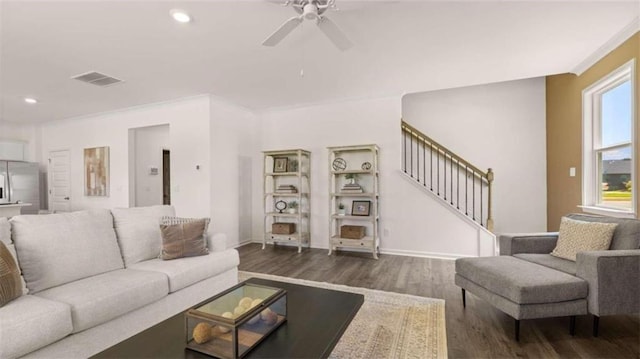 living room featuring ceiling fan, dark hardwood / wood-style flooring, and a healthy amount of sunlight