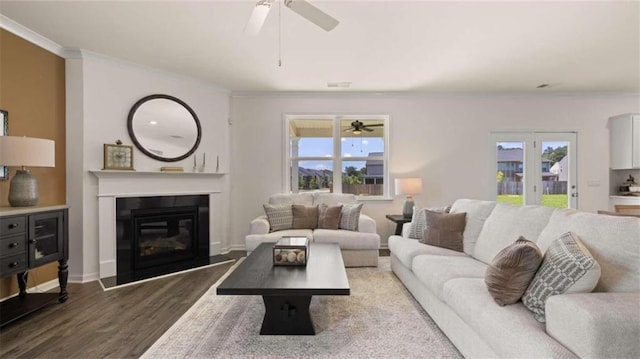 living room featuring crown molding, ceiling fan, and wood-type flooring