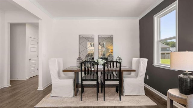 dining space featuring crown molding and dark wood-type flooring