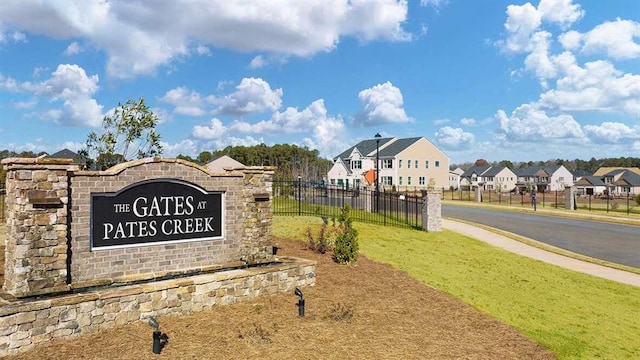 community sign featuring a lawn