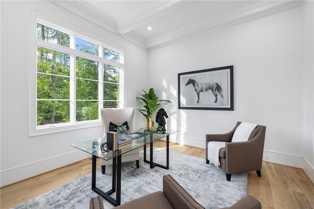 home office featuring light hardwood / wood-style flooring, beamed ceiling, and a healthy amount of sunlight