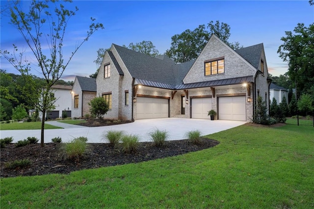 view of front of house featuring a lawn and a garage