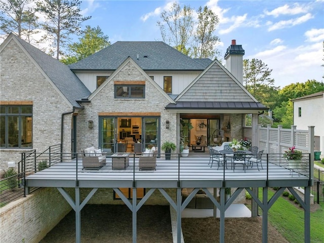 rear view of property with a wooden deck