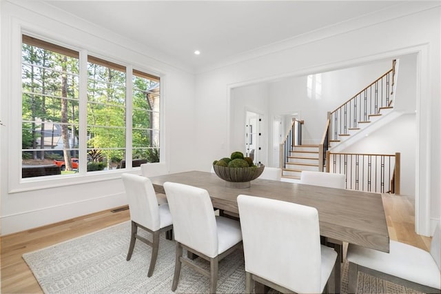 dining room with hardwood / wood-style floors and ornamental molding