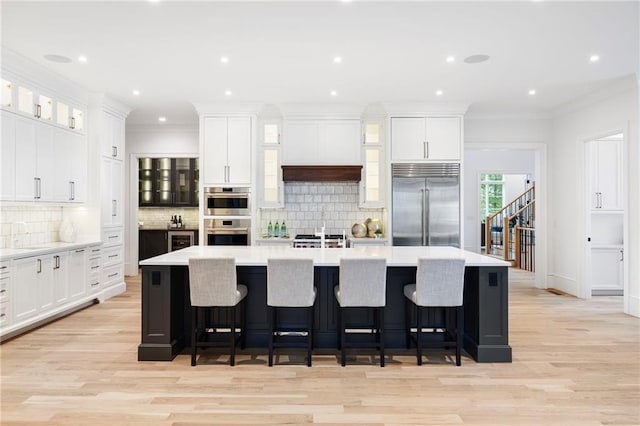 kitchen featuring white cabinetry, a large island, and stainless steel appliances