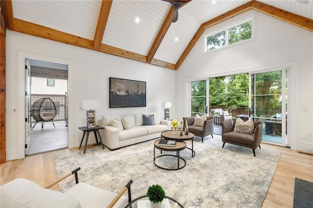 living room with beamed ceiling, light wood-type flooring, high vaulted ceiling, and ceiling fan