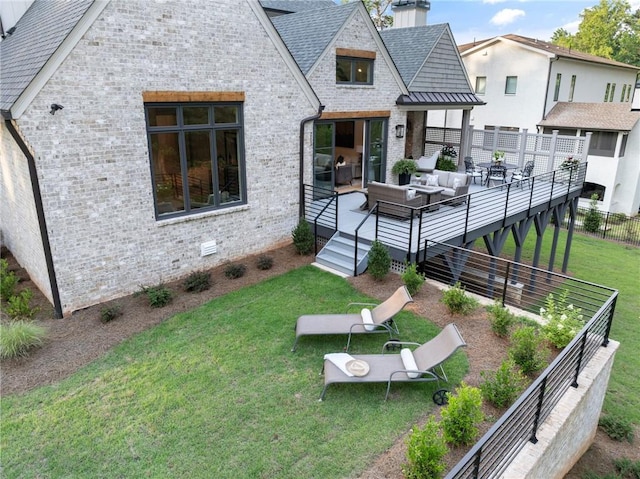 rear view of property featuring a lawn, outdoor lounge area, and a wooden deck