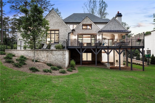 rear view of property with a lawn and a deck