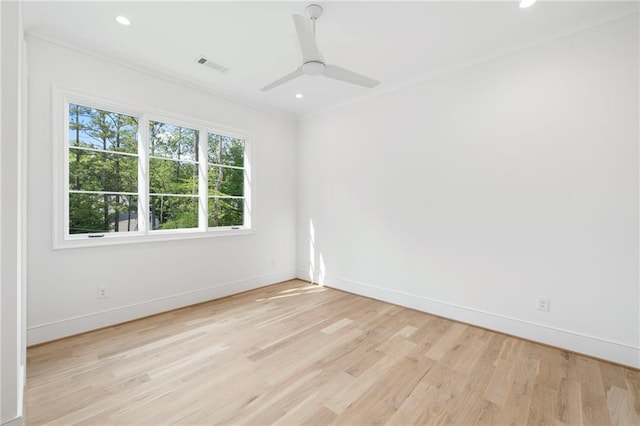 unfurnished room featuring ceiling fan, light hardwood / wood-style floors, and ornamental molding