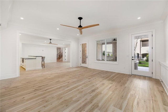 unfurnished living room with ceiling fan, light hardwood / wood-style flooring, and crown molding