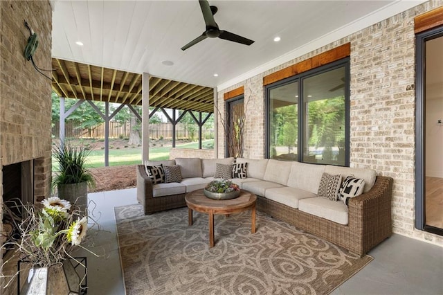 sunroom / solarium featuring an outdoor brick fireplace and ceiling fan