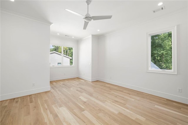 empty room with ceiling fan, light hardwood / wood-style floors, and ornamental molding