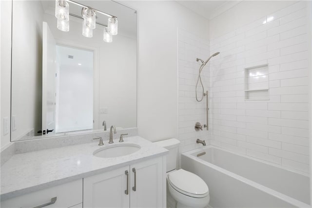 full bathroom featuring vanity, tiled shower / bath, and toilet