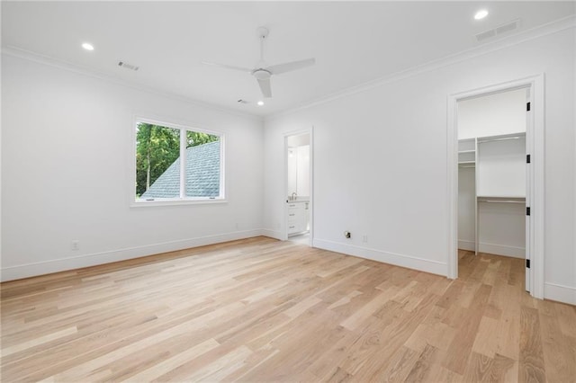 unfurnished bedroom with ceiling fan, light hardwood / wood-style flooring, a walk in closet, a closet, and ornamental molding