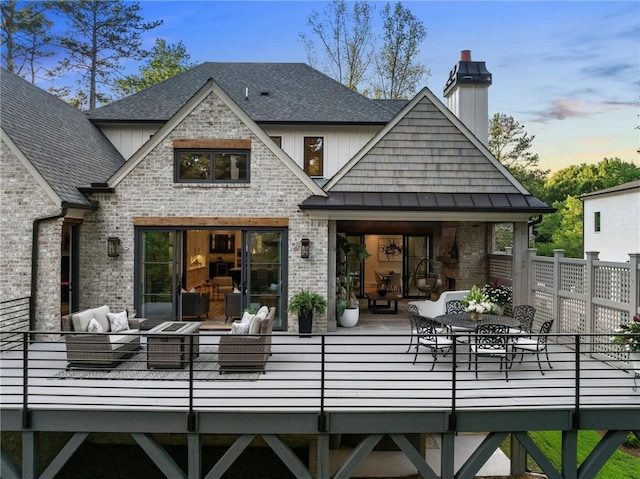 back house at dusk featuring an outdoor living space