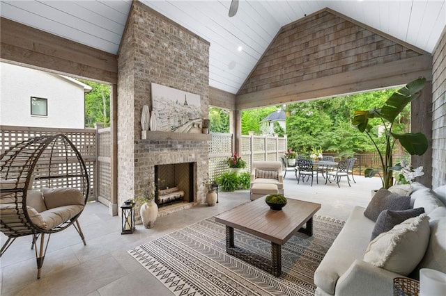 view of patio featuring an outdoor living space with a fireplace and a gazebo