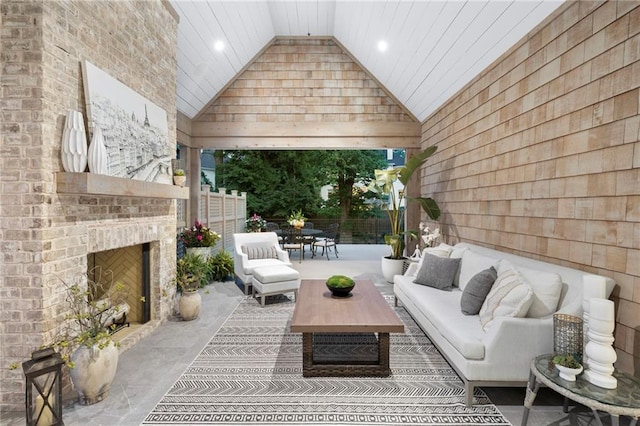 sunroom / solarium with a fireplace and vaulted ceiling