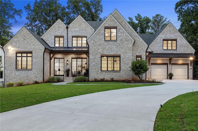 view of front of property with a garage and a yard