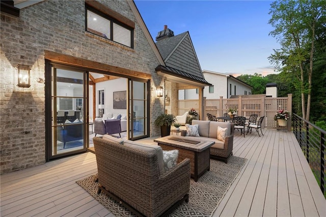 deck at dusk with outdoor lounge area