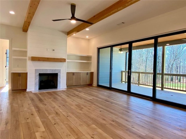 9224 Waldrip Rd, Gainesville, GA 30506 - unfurnished living room with beam ceiling, a ceiling fan, hardwood / wood-style floors, a premium fireplace, and built in shelves