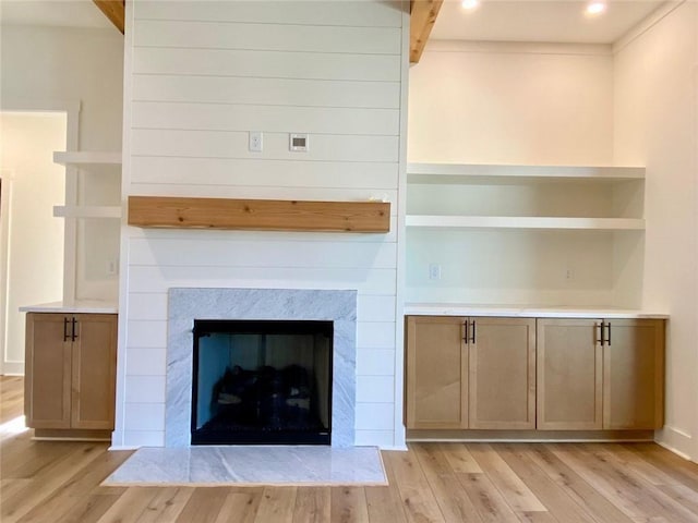 9224 Waldrip Rd, Gainesville, GA 30506 - detailed view of wood finished floors, beam ceiling, and a fireplace with flush hearth