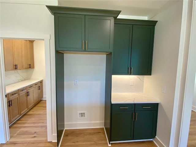 9224 Waldrip Rd, Gainesville, GA 30506 - kitchen with green cabinetry, tasteful backsplash, light wood-type flooring, and baseboards