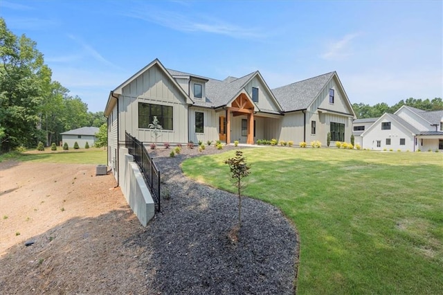 9224 Waldrip Rd, Gainesville, GA 30506 - modern farmhouse featuring board and batten siding, a front yard, and central AC