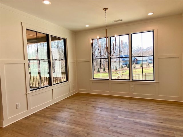 9224 Waldrip Rd, Gainesville, GA 30506 - unfurnished dining area with a decorative wall, light wood-type flooring, and recessed lighting