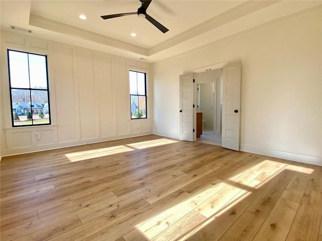 9224 Waldrip Rd, Gainesville, GA 30506 - unfurnished bedroom with a tray ceiling, multiple windows, light wood-style flooring, ceiling fan, and recessed lighting