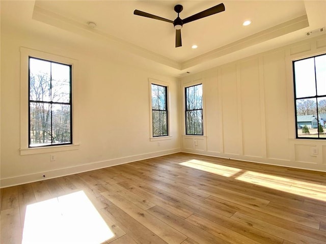 9224 Waldrip Rd, Gainesville, GA 30506 - unfurnished room featuring a tray ceiling, light wood finished floors, plenty of natural light, ceiling fan, and recessed lighting