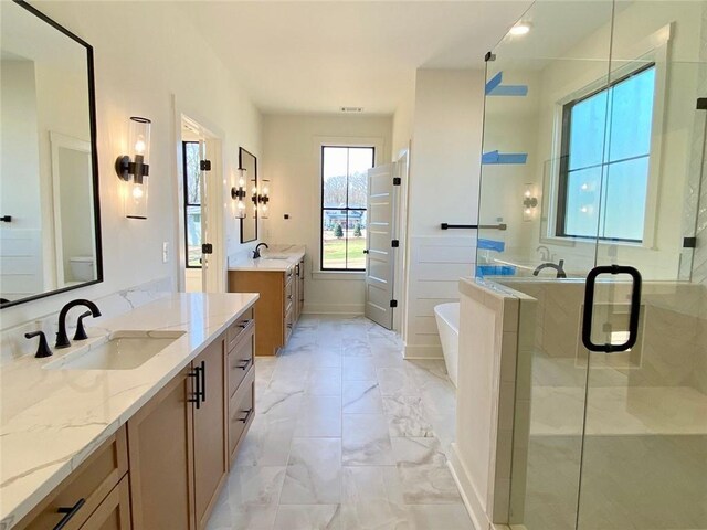 9224 Waldrip Rd, Gainesville, GA 30506 - bathroom featuring marble finish flooring, two vanities, a shower stall, and a freestanding bath