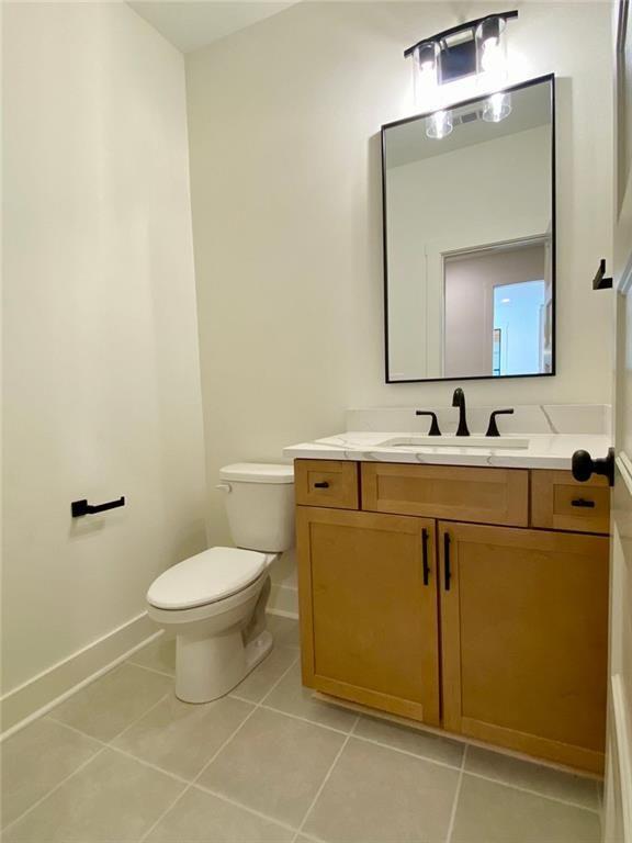 9224 Waldrip Rd, Gainesville, GA 30506 - bathroom featuring tile patterned flooring, toilet, vanity, and baseboards