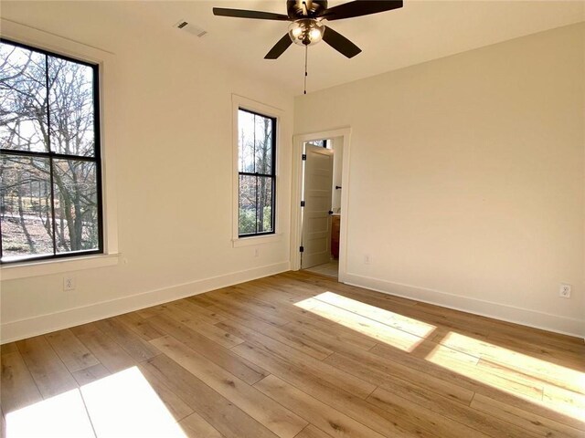 9224 Waldrip Rd, Gainesville, GA 30506 - unfurnished room with baseboards, plenty of natural light, ceiling fan, and light wood finished floors