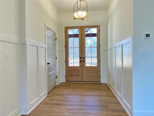 9224 Waldrip Rd, Gainesville, GA 30506 - entryway featuring a decorative wall, french doors, ornamental molding, and light wood-type flooring