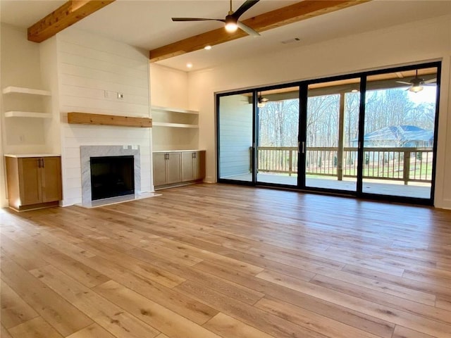 9224 Waldrip Rd, Gainesville, GA 30506 - unfurnished living room with ceiling fan, beamed ceiling, light wood-type flooring, and a high end fireplace