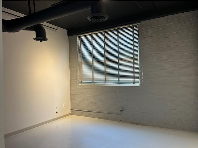 unfurnished room with concrete floors