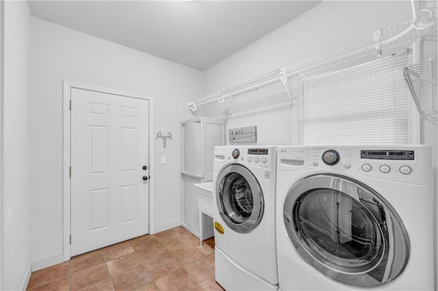 laundry area featuring laundry area, washer and clothes dryer, and baseboards