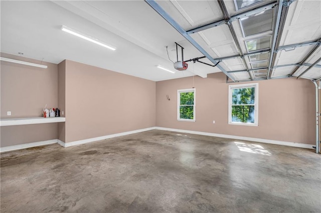 garage with baseboards and a garage door opener