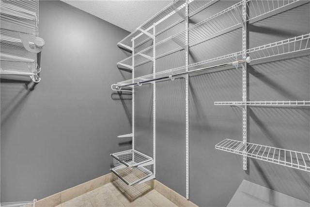 spacious closet with tile patterned flooring