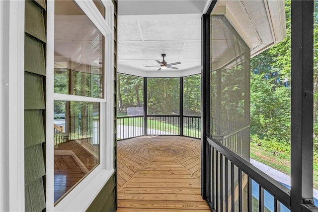 unfurnished sunroom featuring a ceiling fan
