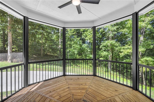 unfurnished sunroom with a ceiling fan