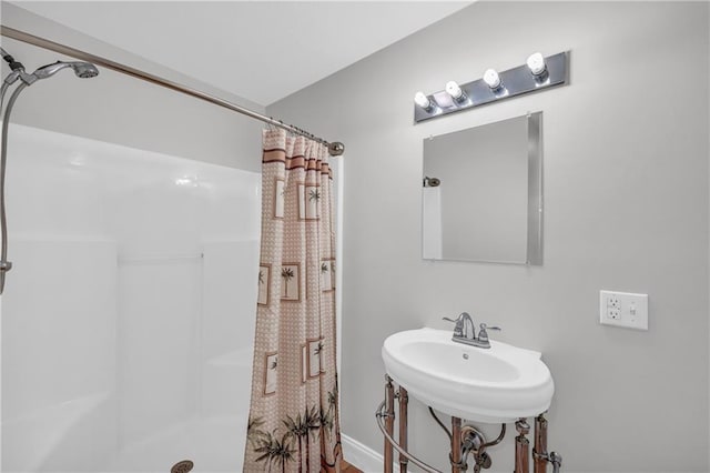 bathroom with a sink and a shower with shower curtain