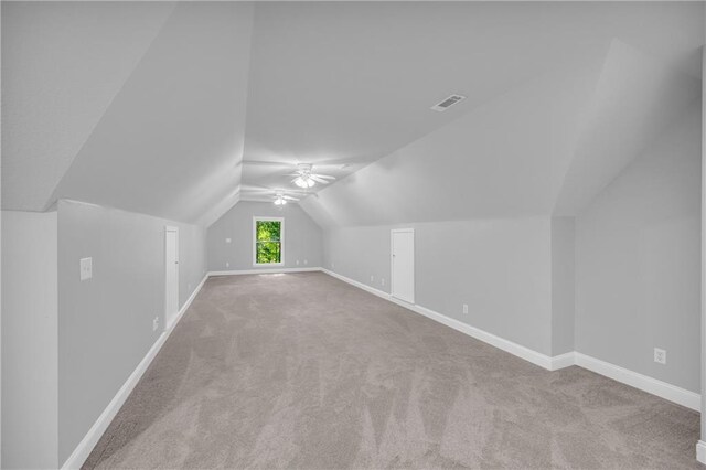 additional living space with baseboards, carpet, and visible vents