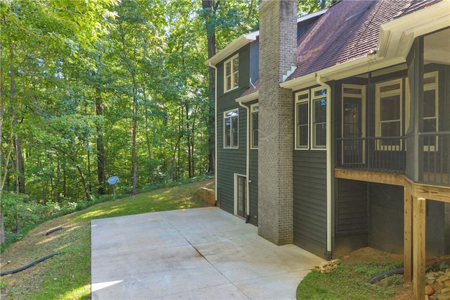 exterior space featuring a chimney and a patio area