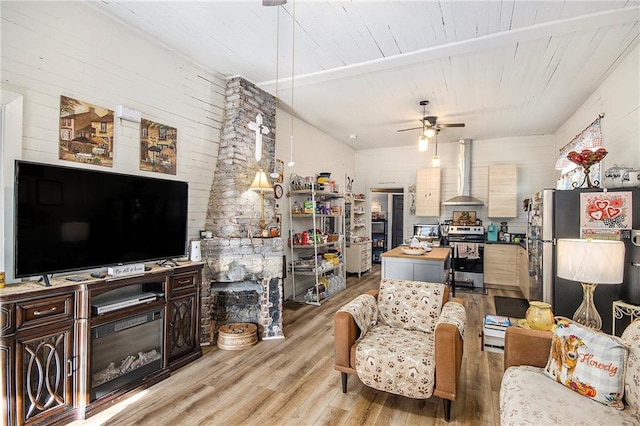 living room featuring ceiling fan and light hardwood / wood-style flooring