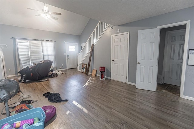 interior space with vaulted ceiling, dark wood-type flooring, ceiling fan, and a textured ceiling