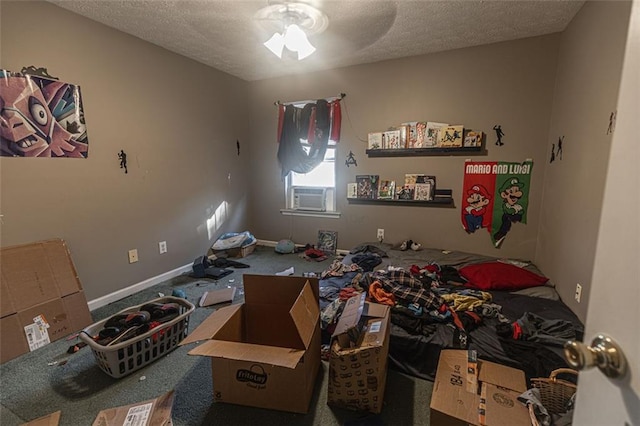 bedroom featuring carpet flooring, cooling unit, a textured ceiling, and ceiling fan