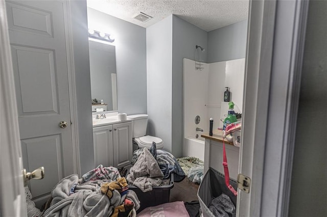 full bathroom with vanity, hardwood / wood-style floors, shower / washtub combination, and a textured ceiling